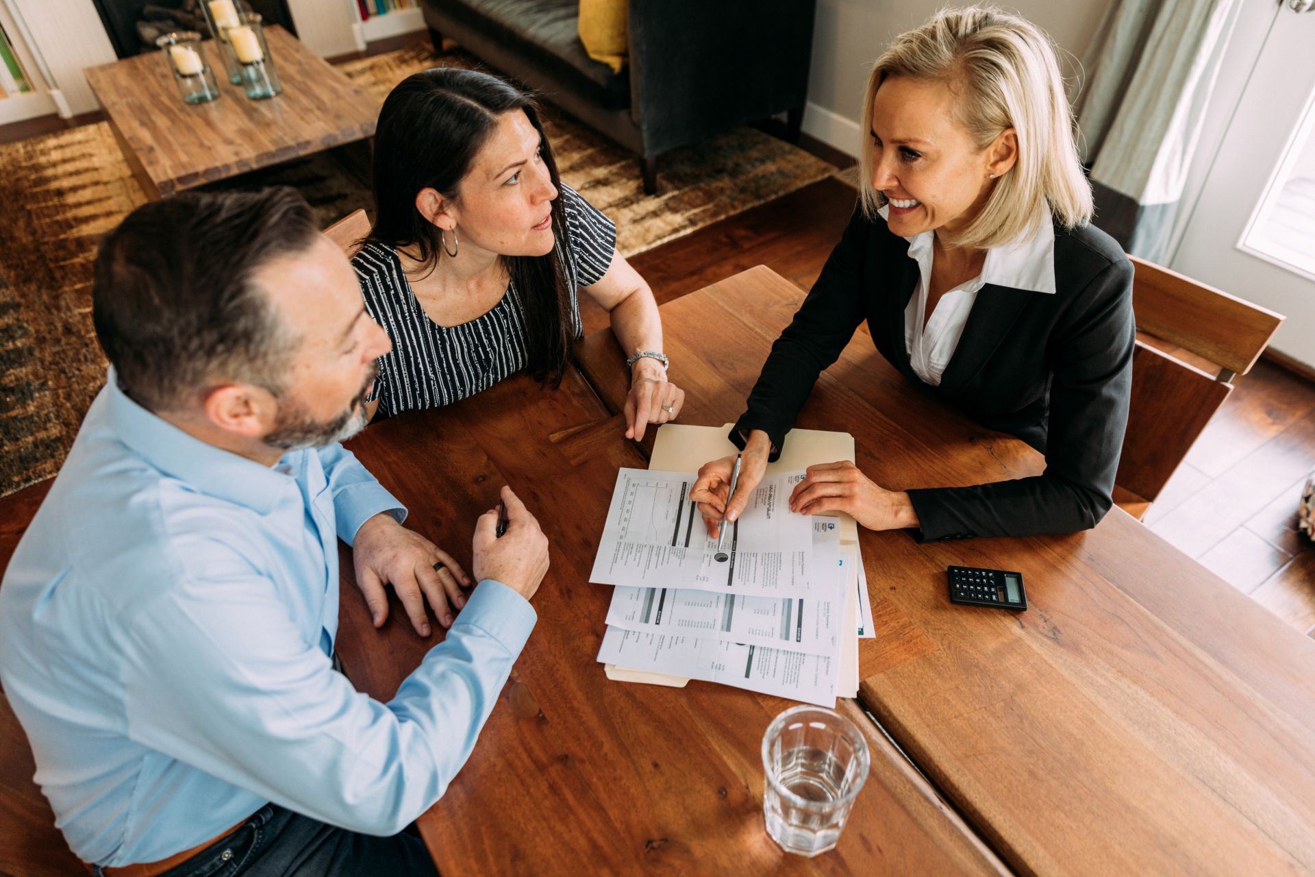 A business woman offering a contract to a couple