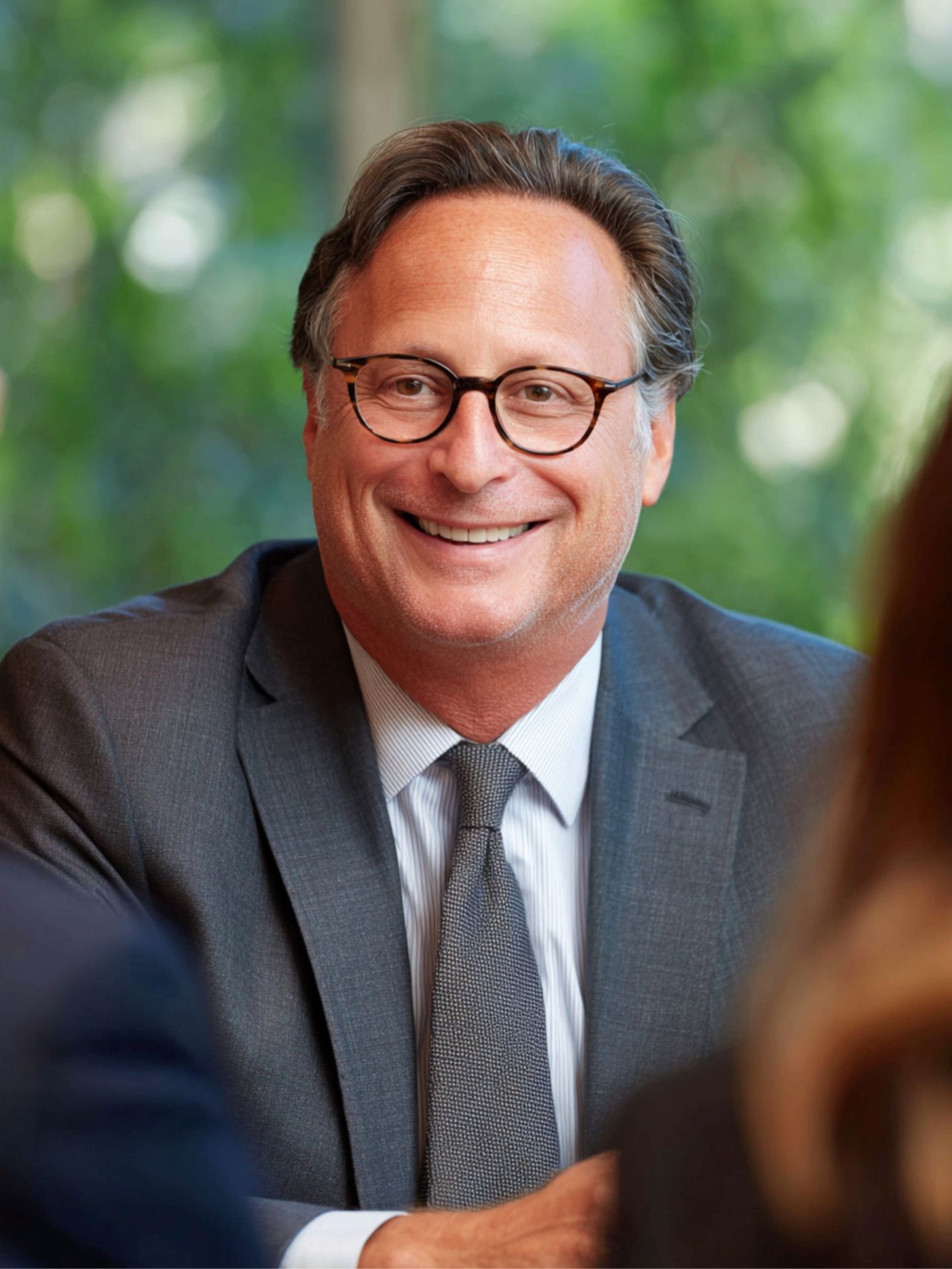 A man in glasses smiling