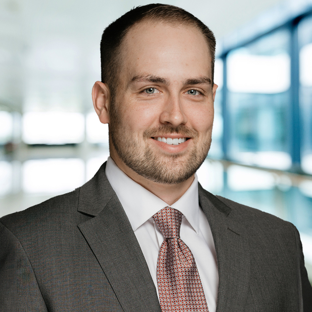 A man in a suit smiling at the camera