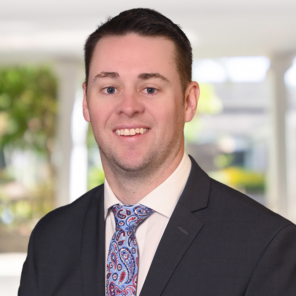 A man in a suit smiling at the camera